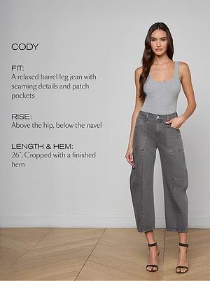 Woman wearing gray jeans with product details on a plain background