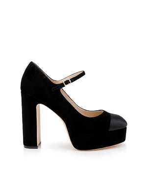 The Lilles Platform Pump is a black suede Mary Jane with a rounded toe, thick high heel, ankle strap and buckle, and beige sole—an elegant shoe shown in profile against a white background.